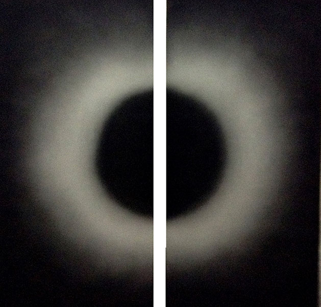 Sun meeting the moon in a corner or half cut black circle and half cut white circle in darkness , 2016